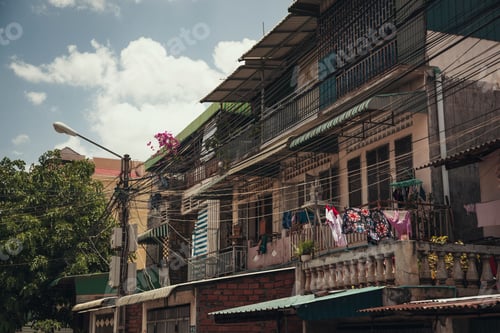 Preview: Shot of old traditional houses with hanging clothes on balconies in Cambodia