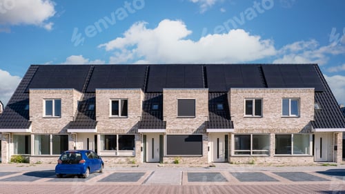 Aperçu: Newly build houses with solar panels attached on the roof against a sunny sky