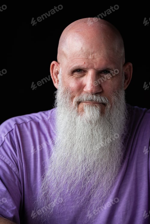 Preview: Portrait of man with long gray beard wearing purple t-shirt close-up shot