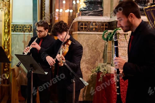 Preview: Musicians performing classical concert in historical church setting during evening