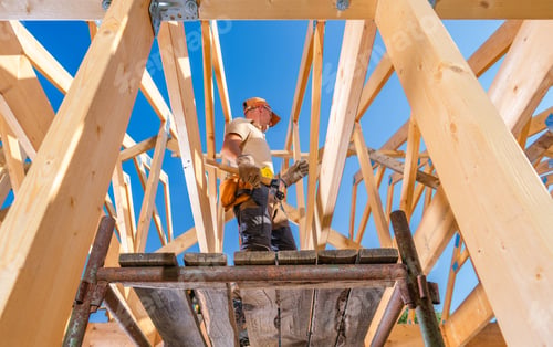Preview: Construction Worker on Scaffolding Under Blue Sky