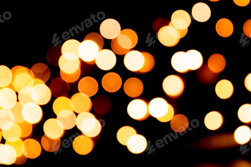 Preview: Holiday glowing gold backdrop. defocused and blurred many round yellow light
