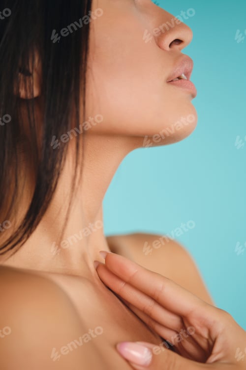 Preview: Close up side view of tender Asian brunette girl posing over colorful background