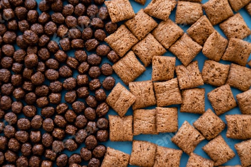 Preview: top view of tasty chocolate cereal balls and puffs on blue