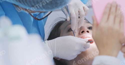 Preview: Woman checking on her teeth in dental office