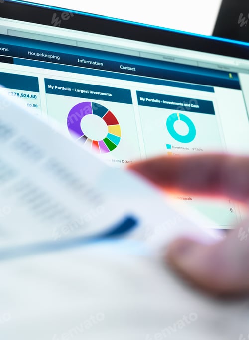 Preview: Investor checking performance of financial portfolio online whilst reviewing investment statement