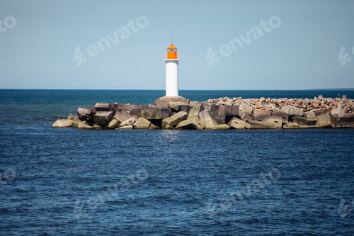 Preview: road to the lighthouse with concrete breakwaters