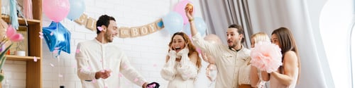 Preview: Excited couple blowing up surprise balloon during gender reveal party
