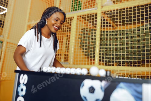 Preview: International couple playing a table football in a club