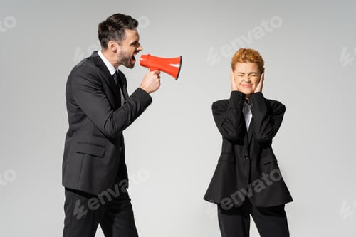 Preview: redhead manager with closed eyes covering ears with hands near boss screaming in megaphone isolated