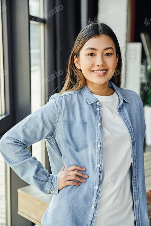 Preview: Smiling Woman in Denim Shirt Poses Indoors