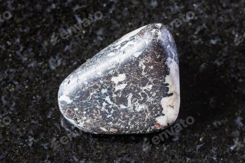 Preview: sample of tumbled trachybasalt rock on black