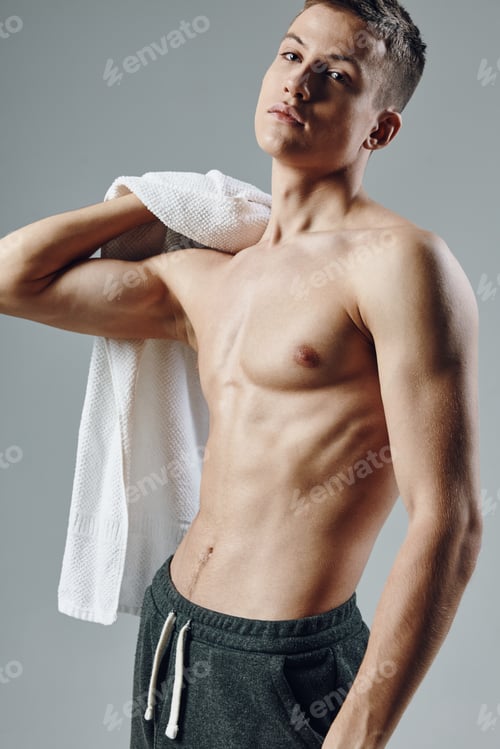 Preview: man with towel in hands pumped up press workout isolated background
