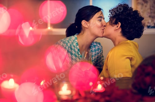 Preview: Lesbian couple kissing during dinner