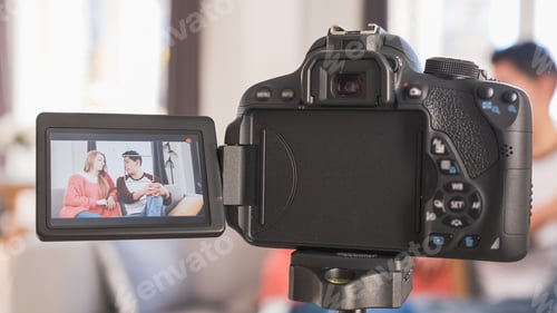 Preview: Young couple talking to camera on screen. Woman and man recording a video blog