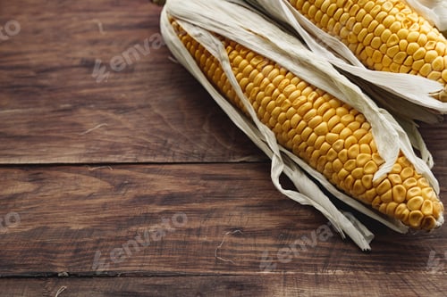 Preview: Corn cobs on dark brown wooden table