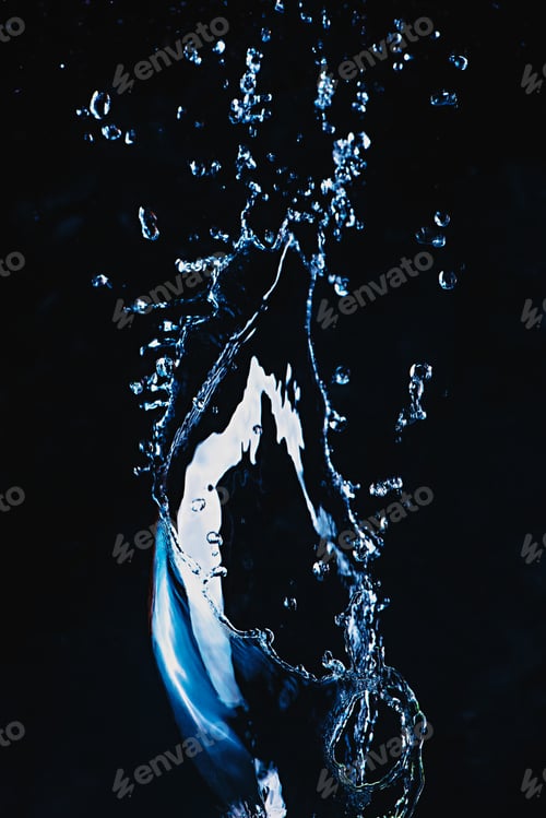 Preview: Dynamic splash of water on a dark background. Flying transparent liquid with a shiny surface. High