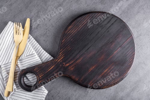 Preview: Wooden cutting board or food serving board with napkin and cutlery