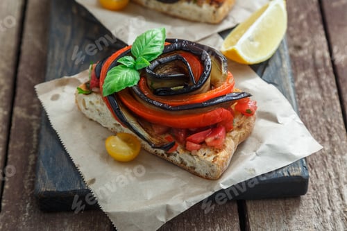 Preview: Close view of bruschettas with eggplant, bell pepper and basil