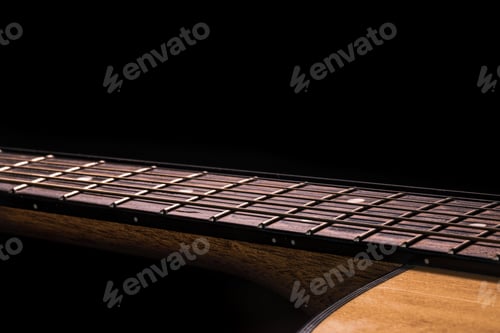 Preview: Close-up of an acoustic guitar fretboard copy space.