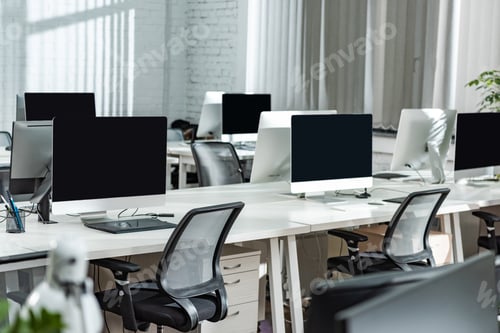 Preview: modern open space office with computer monitors on white desks