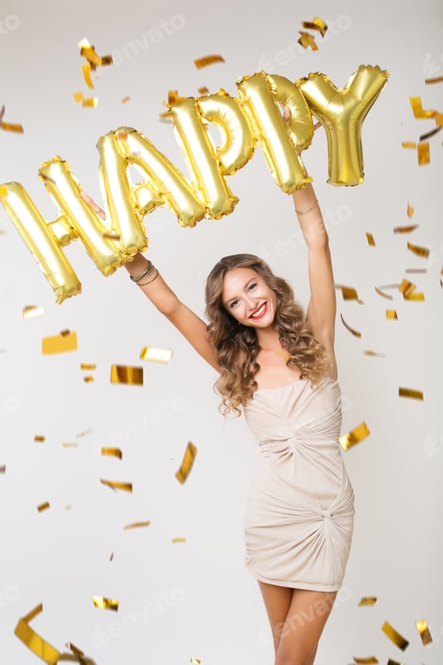 Preview: pretty woman celebrating party in golden confetti