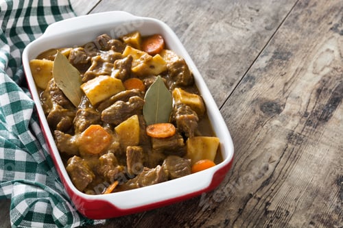 Preview: Delicious beef stew with potatoes and carrots simmering in a baking dish