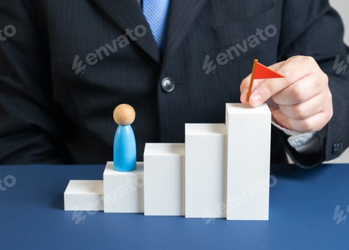 Preview: A businessman sets a goal at the pinnacle of a challenge. Steps to reaching the flag
