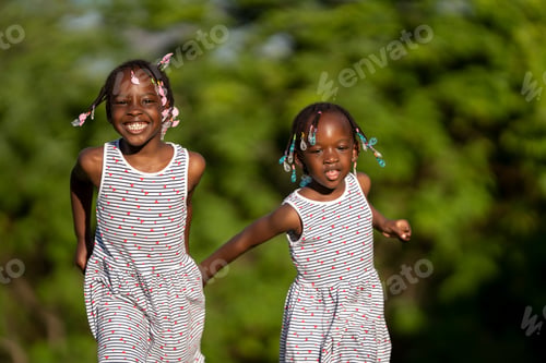Preview: Two black-skinned sisters playing at sunset in the park
