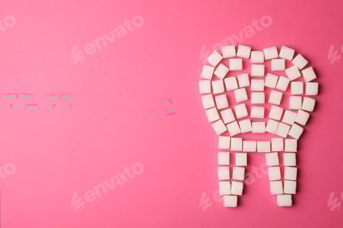 Preview: Tooth made of sugar cubes on pink background, top view