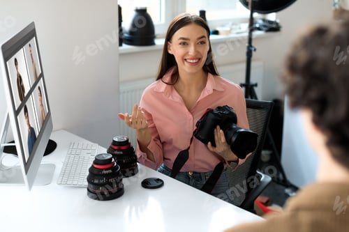 Preview: The art of feedback. Young photographer lady showing results of photoshoot to guy, discussing photos
