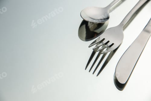 Preview: bottom view fork knife spoon on light background with copy space