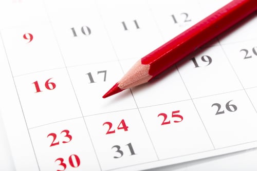 Preview: Red pencil marking important date on a calendar for planning and organization