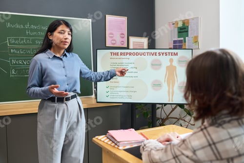 Preview: Young Adult Hispanic Woman Explaining Reproductive System to Teenage Girl