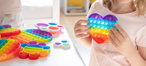 Preview: Little girl,kid,child plays with colorful pop it children's room, bedroom.Funny trendy silicone anti