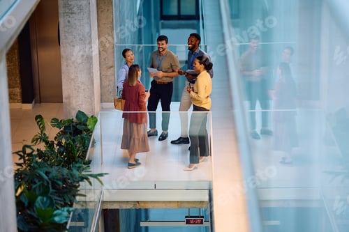 Preview: Above view of happy coworkers having business meeting in the office.
