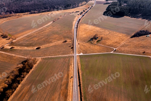 Preview: Aerial view of a road surrounded by agricultural fields.