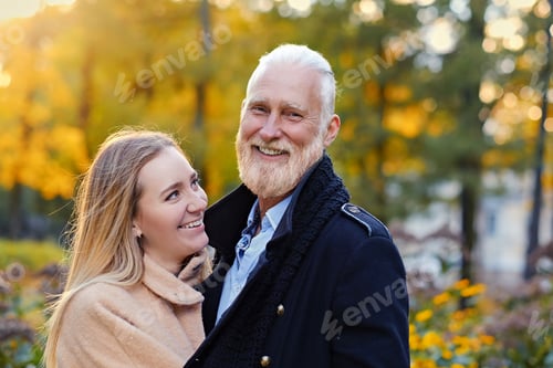 Preview: Senior man and his granddaughter in peaceful autumnal forest