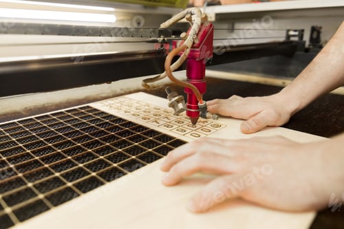 Preview: Laser plywood machine in process close up.