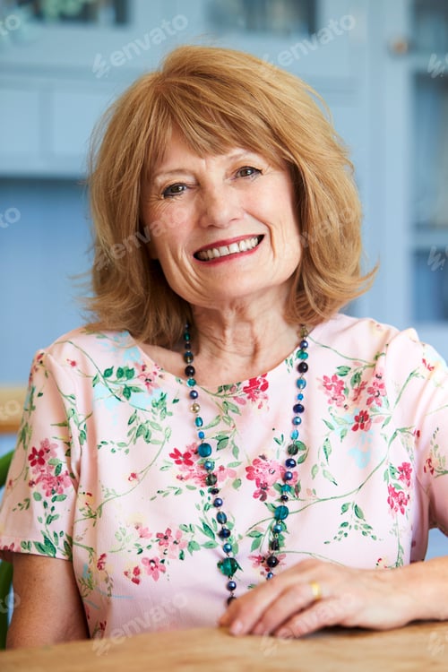 Preview: Portrait Of Smiling Senior Woman At Home Sitting At Table