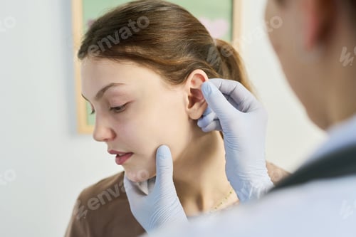 Preview: Medical Professional Examining Patient's Ear in Clinic