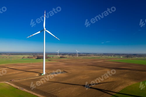 Preview: Flying above ecological wind turbines in a field