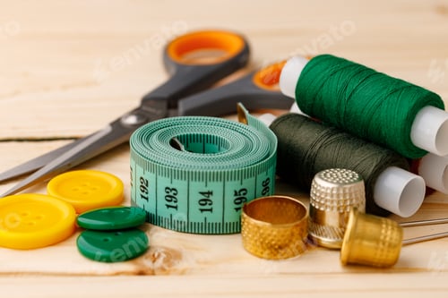 Preview: Threads and sewing accessories on wooden table