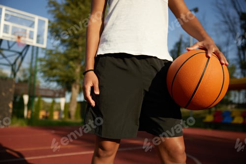 Preview: Basketball ball in hand of young girl player