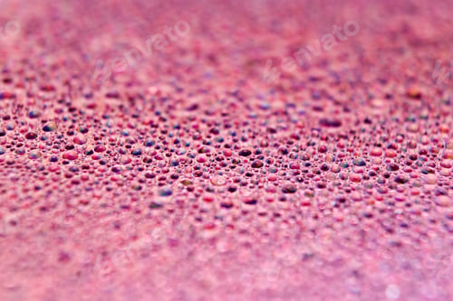 Preview: Selective focus shot of colorful reflective water drops on a digital disc surface