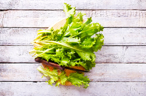 Preview: ripe organic green salad on a cutting board