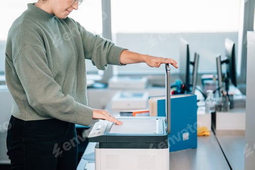 Preview: Female office worker using the printer at the office