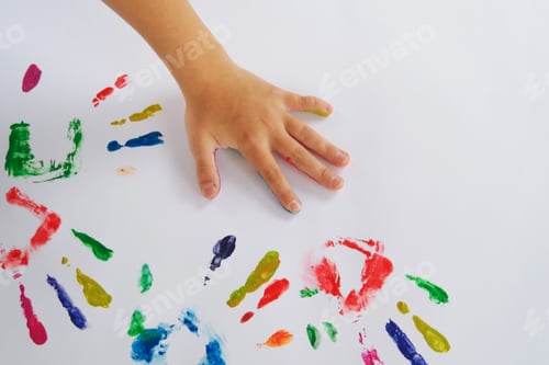 Preview: a child's hand painted with different colors leaves imprints