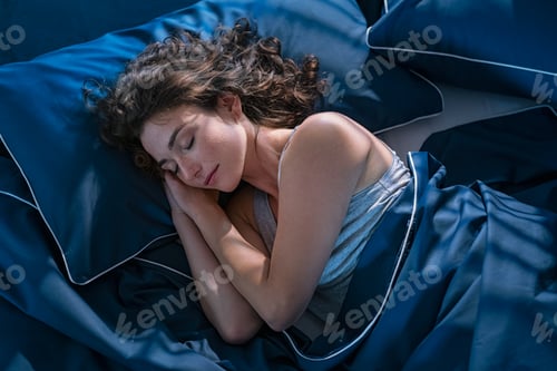 Preview: Young woman sleeping profoundly at night