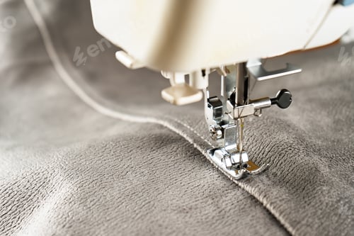 Preview: Modern sewing machine and gray fabric. Sewing process, handmade, hobby, DIY, business, repair